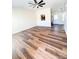 Open-concept living room with wood-look flooring leading into the kitchen at 2307 Hope Valley Ln, Charlotte, NC 28213
