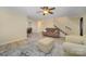 Spacious living room featuring hardwood floors, a cozy sofa, and an open layout to the dining area at 2325 Seymore Ave, Albemarle, NC 28001