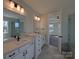 Bathroom featuring double sink vanities, modern lighting, and views into shower and main bedroom at 251 Luray Way # 441, Rock Hill, SC 29730