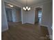 Open dining area with modern chandelier and hardwood floors at 251 Luray Way # 441, Rock Hill, SC 29730