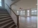 Open-concept living space featuring hardwood floors, bright windows, and staircase access to upper level at 251 Luray Way # 441, Rock Hill, SC 29730