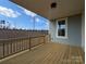 Inviting outdoor porch featuring wood floors, blue siding, and a view of the surrounding landscape at 251 Luray Way # 441, Rock Hill, SC 29730