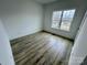 Bright bedroom with neutral walls, wood-look flooring, and a large, bright window at 2705 Eagle Dr, Lincolnton, NC 28092