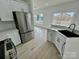 Bright kitchen with white cabinets, stainless steel fridge, and a view to the backyard at 2705 Eagle Dr, Lincolnton, NC 28092