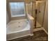 Bright bathroom featuring separate tub and shower at 3121 Strong Box Ln, Gastonia, NC 28052