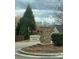 A stone Stagecoach Station entrance sign is framed by mature trees and landscaping at 3121 Strong Box Ln, Gastonia, NC 28052