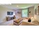 Relaxing living room featuring natural light, plush seating, and entertainment center at 3527 Cramer Creek Dr, Gastonia, NC 28056