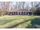 Charming brick home with dark shutters and manicured lawn surrounded by mature trees at 4501 Pine Valley Rd, Charlotte, NC 28210