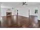 Large, open living room with hardwood floors, fireplace, and neutral wall colors at 4501 Pine Valley Rd, Charlotte, NC 28210