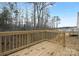 Wooden deck with railing overlooking a wooded area, perfect for outdoor relaxation and enjoying the natural scenery at 5156 Fireweed Ct, Dallas, NC 28034