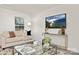 Bright living room with a comfortable beige sofa, modern decor, and large windows providing ample natural light at 5156 Fireweed Ct, Dallas, NC 28034