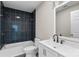 Bathroom with a dark tiled shower and white vanity at 533 3Rd St, Chester, SC 29706