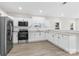Modern kitchen features white cabinets, stainless steel appliances and light gray vinyl plank flooring at 533 3Rd St, Chester, SC 29706
