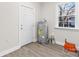 Utility room with hot water heater and exterior door, featuring light gray vinyl plank flooring at 533 3Rd St, Chester, SC 29706