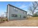 Green home backyard showcasing newly seeded lawn, patio, and wooden perimeter fence with ample space at 600 Campus St, Charlotte, NC 28216