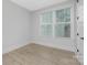 Bright bedroom with ample natural light, featuring wood-style flooring and fresh, neutral paint at 600 Campus St, Charlotte, NC 28216