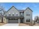 Beautiful new construction home featuring a two-car garage, craftsman details, and a sodded front yard at 600 Campus St, Charlotte, NC 28216