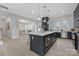 Open concept kitchen featuring navy cabinets, white quartz countertops, stainless appliances, and wood flooring at 600 Campus St, Charlotte, NC 28216
