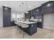 Modern kitchen featuring navy cabinets, a large island, pendant lights, and stainless steel appliances at 600 Campus St, Charlotte, NC 28216