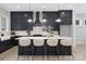 Modern kitchen with navy cabinets, quartz countertops, a subway tile backsplash, and stainless steel appliances at 600 Campus St, Charlotte, NC 28216
