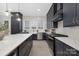 Modern kitchen featuring navy cabinets, white quartz countertops, and stainless steel appliances at 600 Campus St, Charlotte, NC 28216