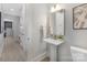 Powder room features a pedestal sink, gold fixtures, and access to hallway and other rooms at 600 Campus St, Charlotte, NC 28216