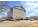 Multi-story building featuring parking garage access and manicured landscaping at 6006 Union Pacific Ave # 2B, Charlotte, NC 28210