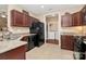 Kitchen with granite counters, black appliances, and view into the laundry room at 6006 Union Pacific Ave # 2B, Charlotte, NC 28210