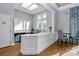 Light and bright kitchenette with white countertops, tile backsplash, and modern fixtures, providing a convenient space for light meal prep at 6006 Union Pacific Ave # 2B, Charlotte, NC 28210