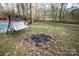 A backyard featuring a swing, firepit, and wood bridge offering relaxation and outdoor enjoyment at 7210 Timber Ridge Dr, Mint Hill, NC 28227