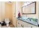 Cozy half bathroom featuring a vessel sink, tile floors, and a traditional toilet at 7210 Timber Ridge Dr, Mint Hill, NC 28227