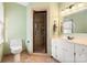 Well-lit bathroom featuring a tiled shower with glass door, vanity sink, and neutral decor at 7210 Timber Ridge Dr, Mint Hill, NC 28227
