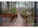 Exterior deck walkway offering a scenic view of the lush, wooded landscape at 7210 Timber Ridge Dr, Mint Hill, NC 28227