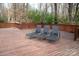 Spacious wooden deck with lounge chairs surrounded by a serene wooded landscape at 7210 Timber Ridge Dr, Mint Hill, NC 28227