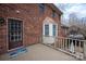 Exterior deck showcases brick home with bay window and view of the backyard at 7210 Timber Ridge Dr, Mint Hill, NC 28227