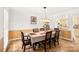 Dining room featuring tile flooring, neutral walls, and a pass-through to the kitchen at 7210 Timber Ridge Dr, Mint Hill, NC 28227