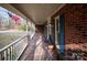 Inviting front porch featuring brick detail, white railings, and ample space for relaxing outdoors at 7210 Timber Ridge Dr, Mint Hill, NC 28227