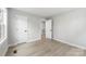 Bedroom with light grey walls and light colored hardwood flooring with two white doors at 723 Wood St, Statesville, NC 28677