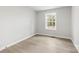 Bedroom with light grey walls and light colored hardwood flooring with a window at 723 Wood St, Statesville, NC 28677