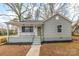 Charming single-story home featuring a cozy front porch, fresh paint, and a well-manicured lawn at 723 Wood St, Statesville, NC 28677