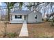 Inviting single-story home with a tidy front yard and a quaint covered porch entrance at 723 Wood St, Statesville, NC 28677