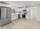Stylish kitchen with stainless steel appliances, white cabinets, and an abundance of natural light at 723 Wood St, Statesville, NC 28677