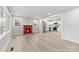 Bright living room with a red-painted fireplace, connecting seamlessly to a modern kitchen at 723 Wood St, Statesville, NC 28677