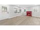 Bright living room with a red fireplace and large windows and white front door at 723 Wood St, Statesville, NC 28677