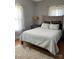 Comfortable bedroom featuring a cozy bed with decorative pillows, bedside tables, and stylish polka dot curtains at 8508 Colgate Cir, Charlotte, NC 28214