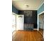 Bright entryway featuring wood floors, fresh paint, a sleek cabinet, and a glass storm door letting in natural light at 8508 Colgate Cir, Charlotte, NC 28214