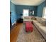 Comfortable living room with a large sectional couch, red ottoman, area rug and natural light from two windows at 8508 Colgate Cir, Charlotte, NC 28214