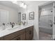 Bright bathroom featuring double vanity, granite counters, and a bathtub shower combo at 889 Regulus Ct, York, SC 29745