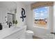 Modern bathroom featuring a large window, granite counters, and a glass-enclosed shower at 889 Regulus Ct, York, SC 29745