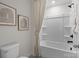 Bright bathroom featuring a bathtub with light neutral shower curtain and modern fixtures at 889 Regulus Ct, York, SC 29745